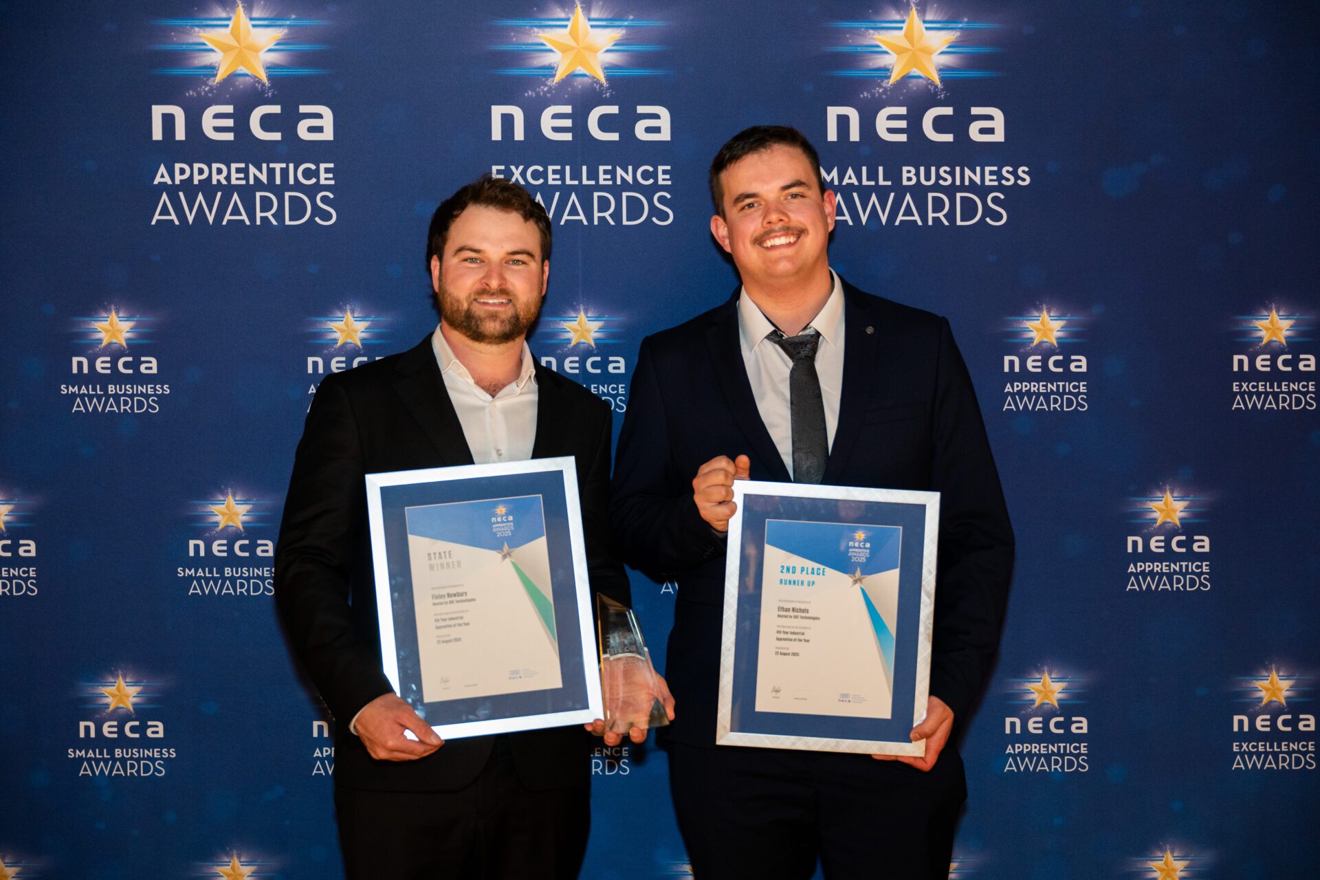 Apprentices holding framed certificates at 2025 NECA Apprentice Awards, including Apprentice of the Year state winner and runner-up